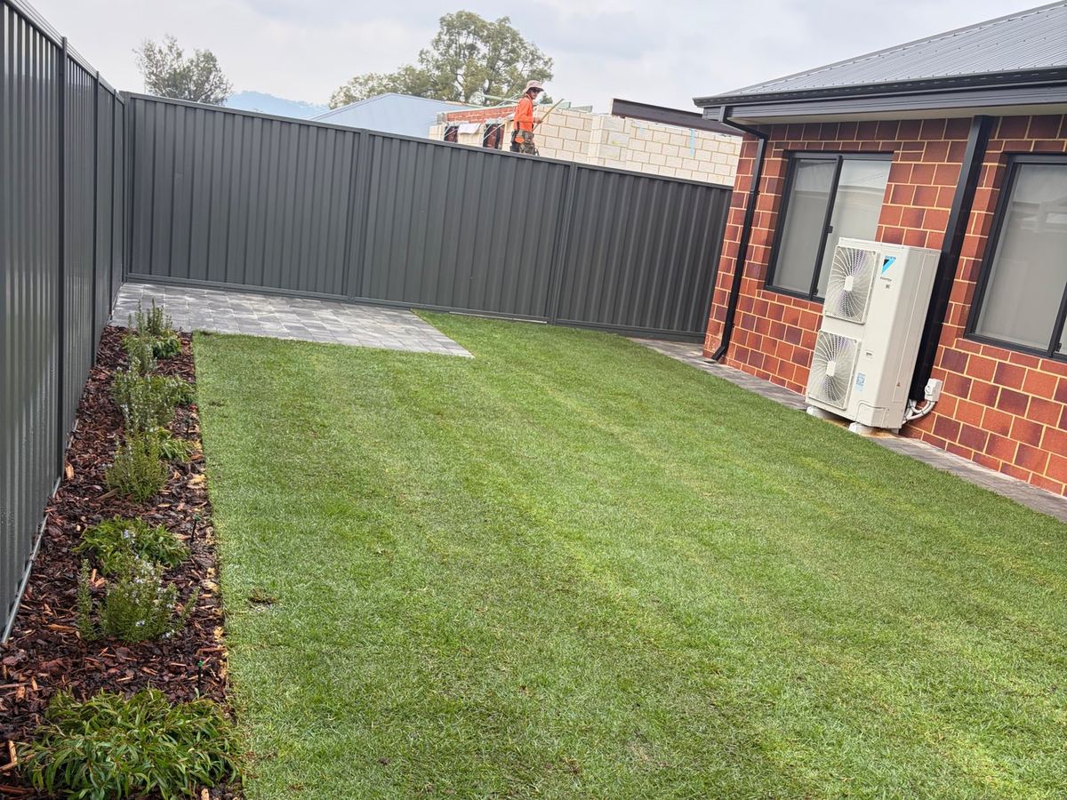 New lawn with mulched garden bed along the fence